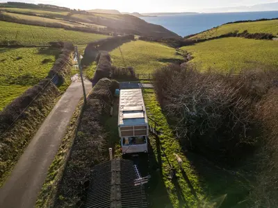 an aerial view of a train traveling through a field at Sea the Stars in New Quay