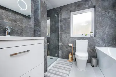 a bathroom with a toilet and a sink and a tub at Llwynblyfyn in Llandeilo