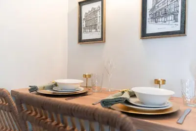 a wooden table with two bowls and plates on it at The Hive, Central Ludlow, Free Parking, Boutique Hotel Style in Ludlow