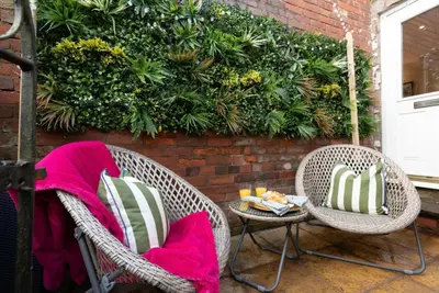 two wicker chairs and a table on a patio at The Hive, Central Ludlow, Free Parking, Boutique Hotel Style in Ludlow