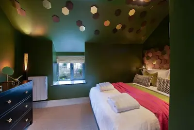 a bedroom with a bed with hearts on the ceiling at The Hive, Central Ludlow, Free Parking, Boutique Hotel Style in Ludlow