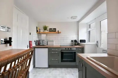 a kitchen with a sink and a stove top oven at The Hive, Central Ludlow, Free Parking, Boutique Hotel Style in Ludlow