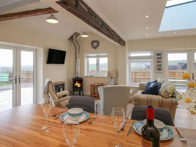 a living room with a table with wine glasses on it at Border View Lodge in Welshpool