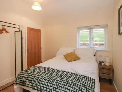 a bedroom with a bed with a black and white blanket at Border View Lodge in Welshpool