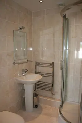a bathroom with a sink and a shower at Penralley House B&B in Rhayader