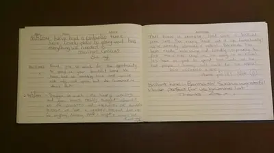 an open book with handwriting on the pages at Penbryn Mynach Holiday Cottage in Barmouth