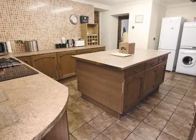 a kitchen with an island in the middle of a kitchen at Penbryn Mynach Holiday Cottage in Barmouth