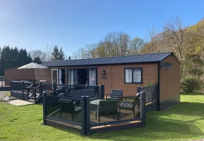 a cabin with a table and chairs in the yard at 43 The Deri in New Quay