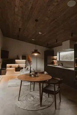 a living room with a table and a kitchen at 3 x bespoke built cabins with hot tubs, mid Wales in Newtown