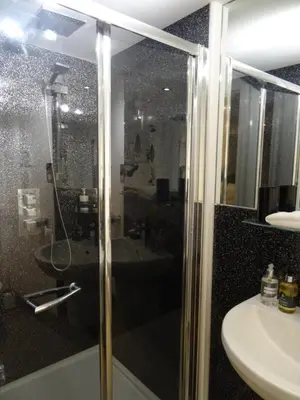 a bathroom with a shower and a sink at Ty Ni Holiday Apartment Aberdovey in Aberdyfi