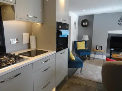 a kitchen with a sink and a stove top oven at Ty Ni Holiday Apartment Aberdovey in Aberdyfi