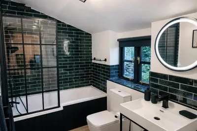 a bathroom with a tub and a toilet and a sink at Glandwr Lodge, 3 bed in Barmouth, Wales in Barmouth
