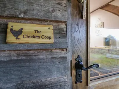 a wooden door with a chicken coop sign on it at The Chicken Coop in Shrewsbury