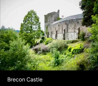 an old castle sitting on top of a hill at Kookaburra lodge in Brecon