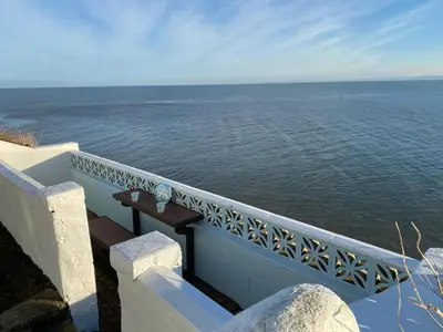 a balcony with a view of the ocean at Min y Graig New Quay in New Quay