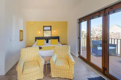a bedroom with a bed and a balcony at Swn y Mor Aberaeron in Aberaeron