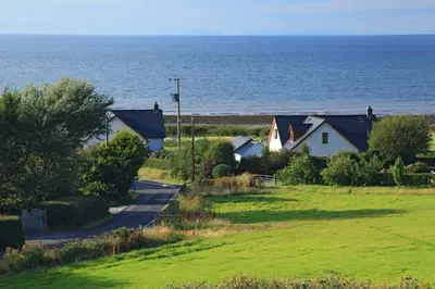 a row of houses next to the ocean at Swn y Mor Aberaeron in Aberaeron