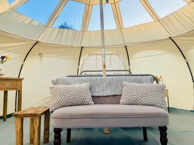 a chair in a tent with a ceiling at Luxury Stargazing Glamping - Seren Hardd with Hot Tub in Llanidloes
