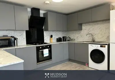 a kitchen with a washer and a dishwasher at Shrewsbury Townhouse with 3 En-suites in Shrewsbury