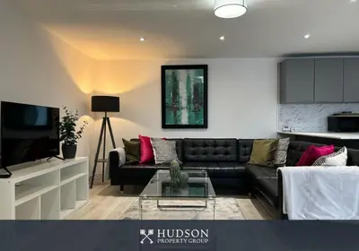 a living room with a couch and a tv at Shrewsbury Townhouse with 3 En-suites in Shrewsbury