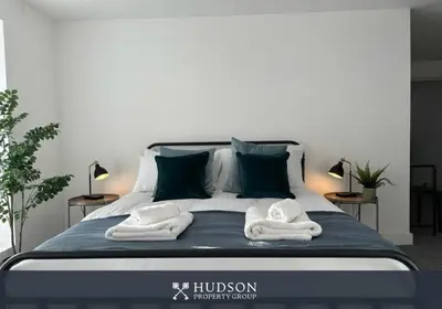 a bedroom with a bed with towels on it at Shrewsbury Townhouse with 3 En-suites in Shrewsbury