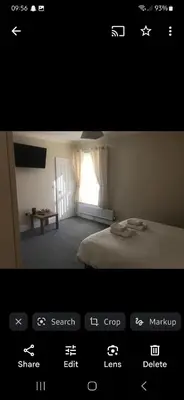 a picture of a bedroom with a bed and a window at Nags Head Pub in Lampeter