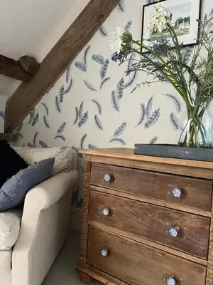 a bedroom with a dresser and a vase with flowers on it at The Pink House in Brecon