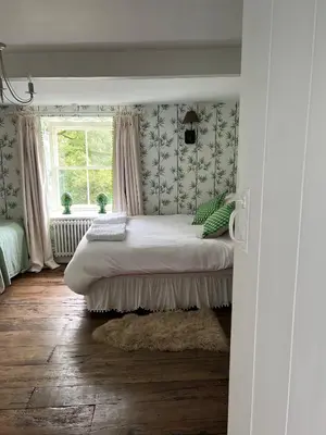 a bedroom with a bed and a window at The Pink House in Brecon
