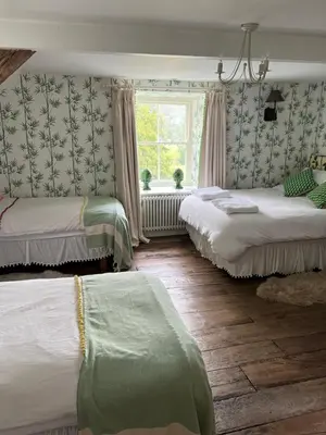 a room with two beds and a window at The Pink House in Brecon