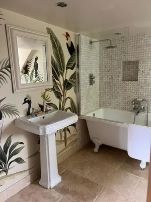 a bathroom with a tub and a sink and a bath tub at The Pink House in Brecon