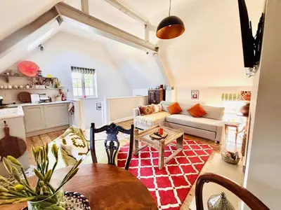 a living room with a couch and a table at The Old Rectory Tack Rooms in Shrewsbury