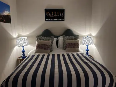 a bedroom with a large bed with two lamps at The Old Rectory Tack Rooms in Shrewsbury