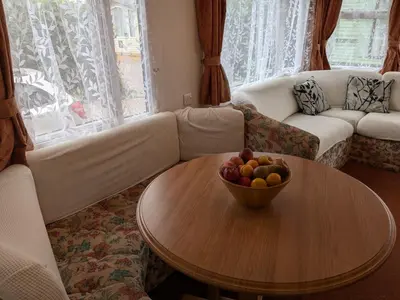 a living room with a bowl of fruit on a table at The fox den in Rhos-gôch