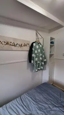 a bedroom with a bed and a green shirt on a wall at Turtle Lodges 29 - Riverside in Builth Wells