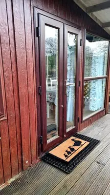 a door of a house with a mat on the porch at Turtle Lodges 29 - Riverside in Builth Wells
