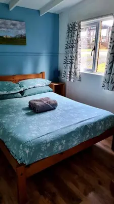 a bedroom with two beds and a window at Turtle Lodges 29 - Riverside in Builth Wells