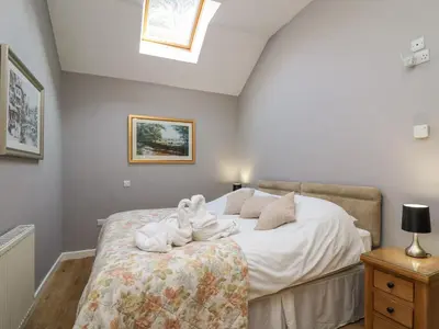 a bedroom with a bed with towels on it at Mynydd ar Mor in Barmouth
