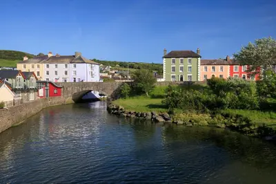 a bridge over a river in a town with buildings at Y Bwthyn Aberaeron in Aberaeron
