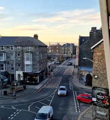 a city street with cars parked on the road at The Penthouse NY Loft Apartment in Barmouth