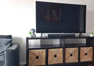 a black entertainment center with a television on top of it at The Penthouse NY Loft Apartment in Barmouth