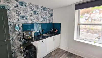 a small kitchen with a sink and a window at The Penthouse NY Loft Apartment in Barmouth