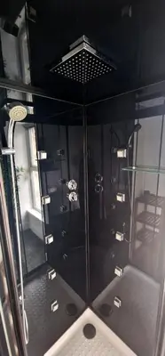 a glass room with a shower in a room at The Penthouse NY Loft Apartment in Barmouth