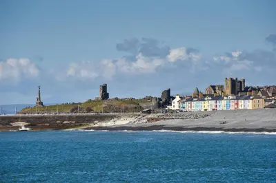 a view of a beach with buildings and the ocean at Plas Hafan Apartment 2 Aberystwyth in Aberystwyth
