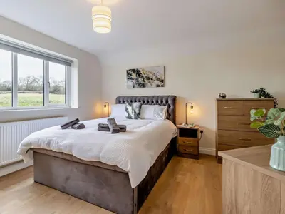 a bedroom with a large bed and a window at 4 Bed in Bishops Castle 94072 in Bishops Castle