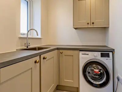 a kitchen with a washing machine and a sink at 4 Bed in Bishops Castle 94072 in Bishops Castle