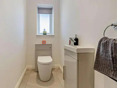 a bathroom with a toilet and a sink and a window at 4 Bed in Bishops Castle 94072 in Bishops Castle
