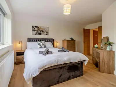 a bedroom with a large bed and a television at 4 Bed in Bishops Castle 94072 in Bishops Castle