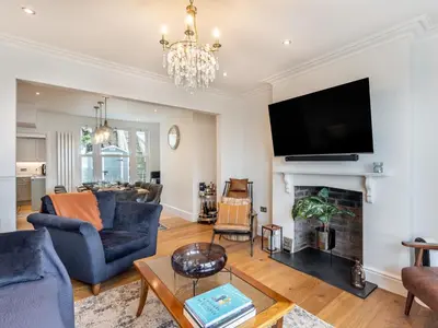 a living room with a fireplace and a tv at 4 Bed in Aberdovey 94232 in Aberdyfi