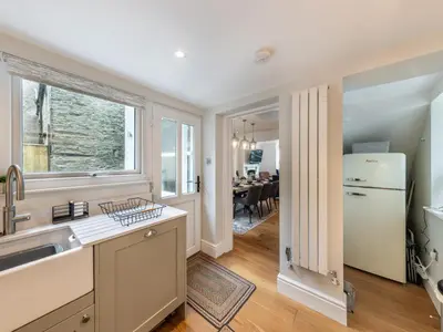 a kitchen with a sink and a refrigerator at 4 Bed in Aberdovey 94232 in Aberdyfi