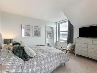 a teddy bear laying on a bed in a bedroom at 4 Bed in Aberdovey 94232 in Aberdyfi